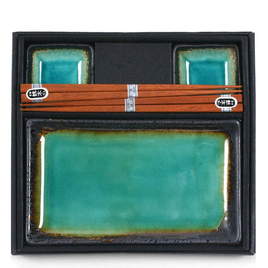 A set of sushi plates for two, including two rectangular plates and two square sauce dishes with wooden chopsticks, featuring a green and brown speckled design.