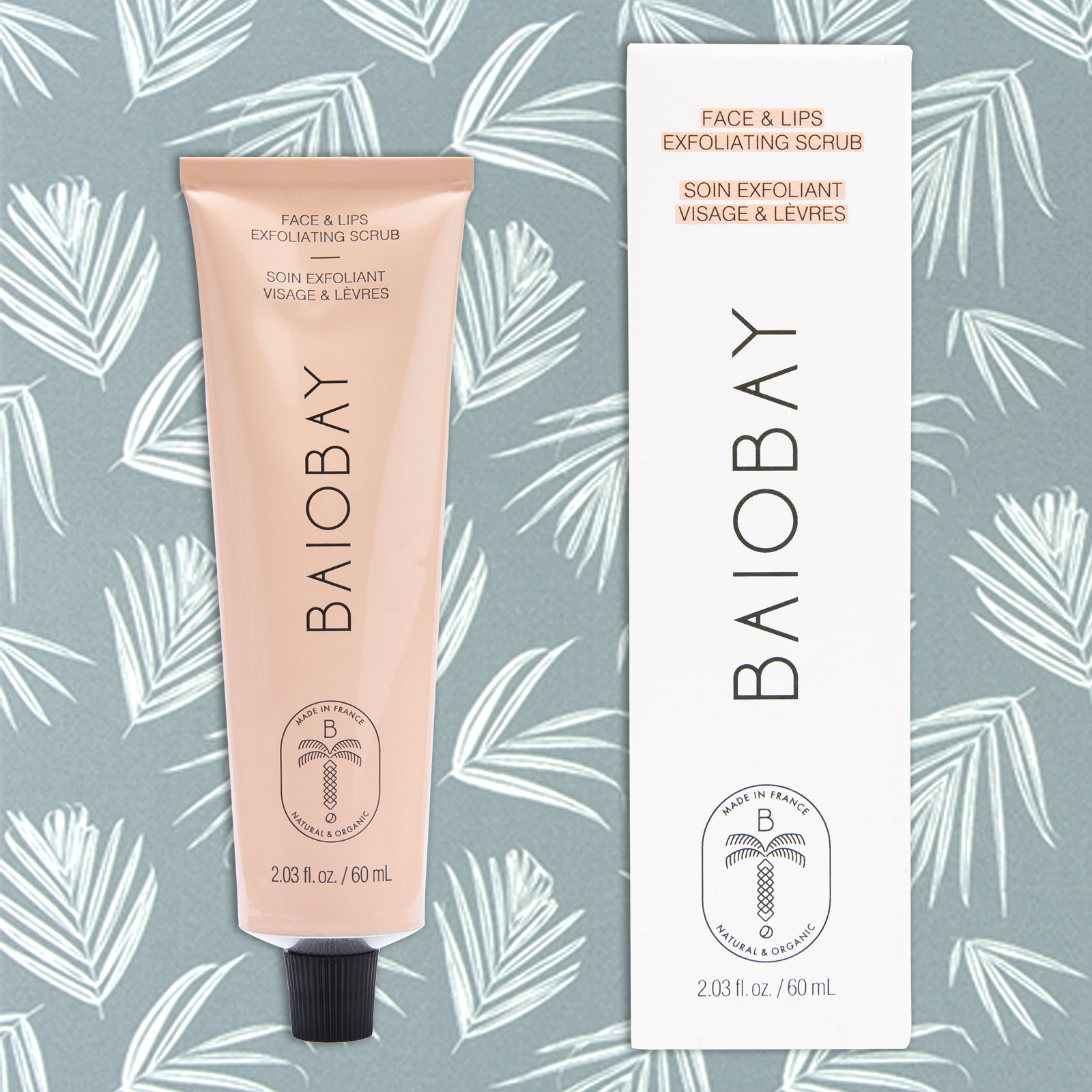 Front side views of BAIOBAY Coconut Oil Face & Lips Exfoliating Scrub tube and box, side by side on a botanical backdrop.