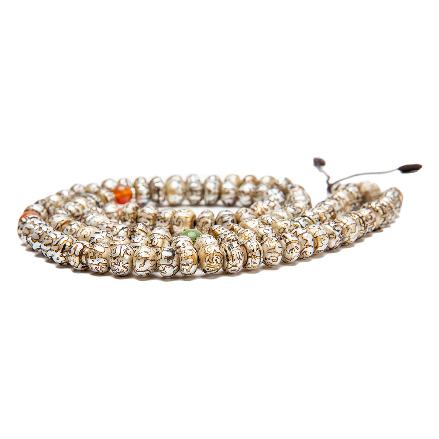 Close-up of the Fresh Water Pearl Mala on a solid white backdrop. The mala rests flat at nearly eye-level. Details on the carvings on the pearl beads are visible.