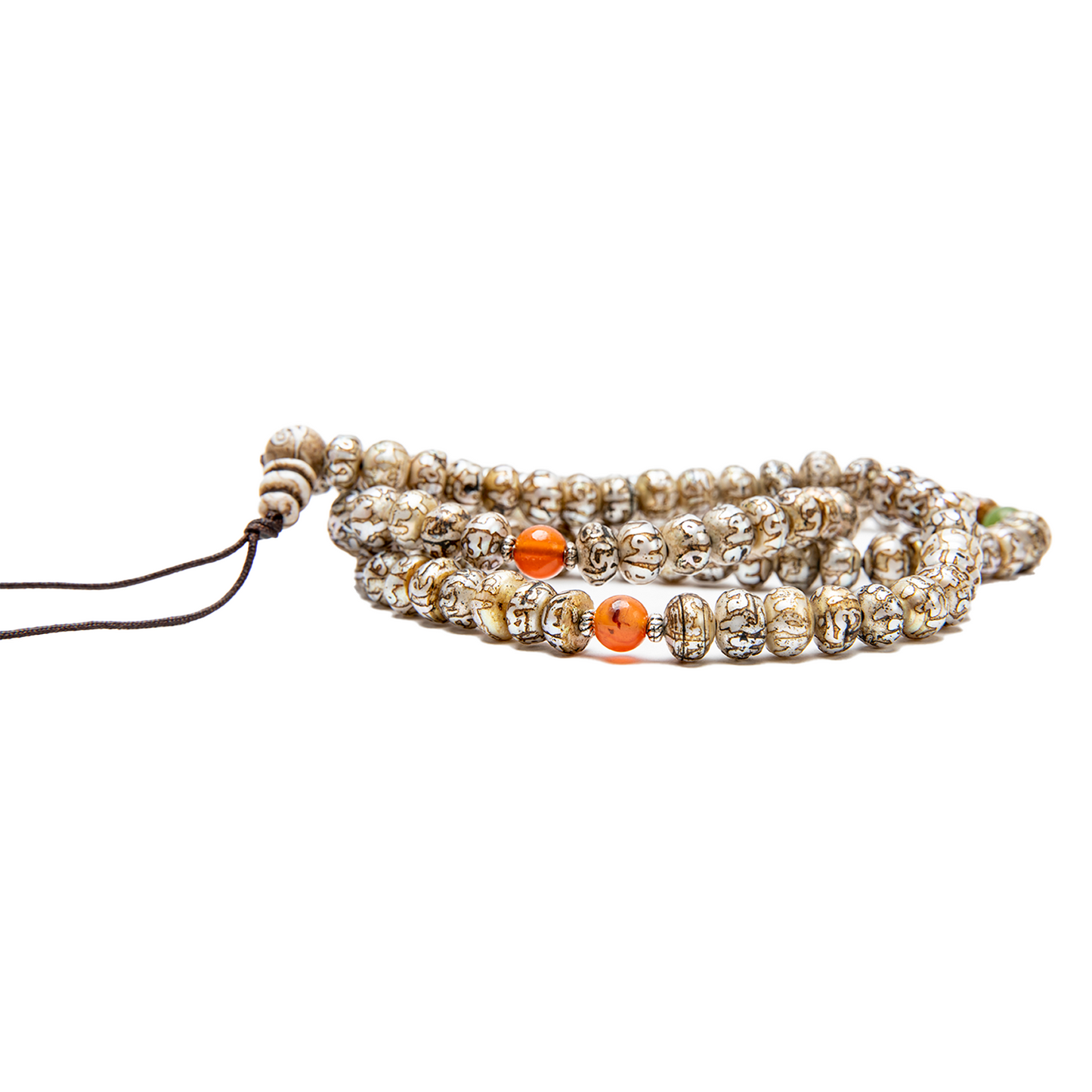 Close-up of the Fresh Water Pearl Mala on a solid white backdrop. The mala rests flat at nearly eye-level, with the carnelian beads on display.