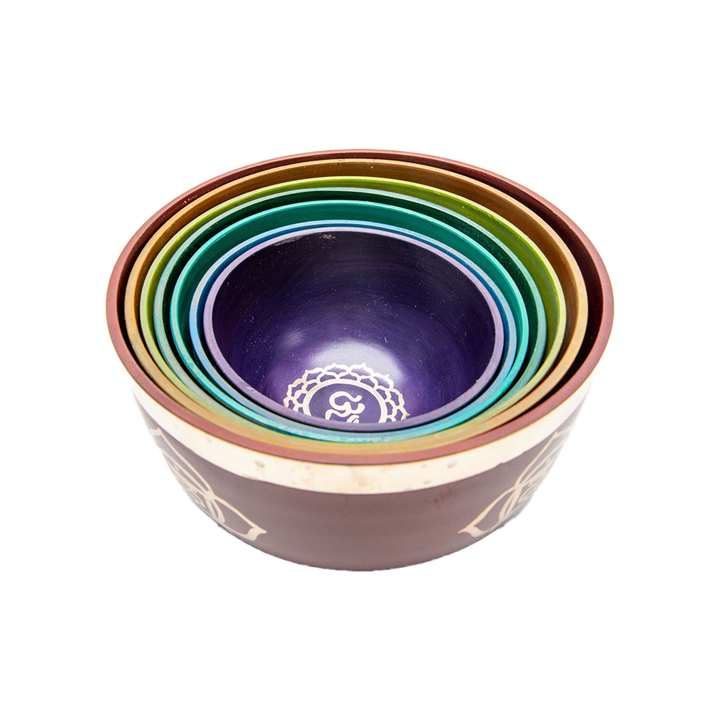 The Chakra 7 Bowl Set is nested together inside of the largest bowl on a white backdrop.