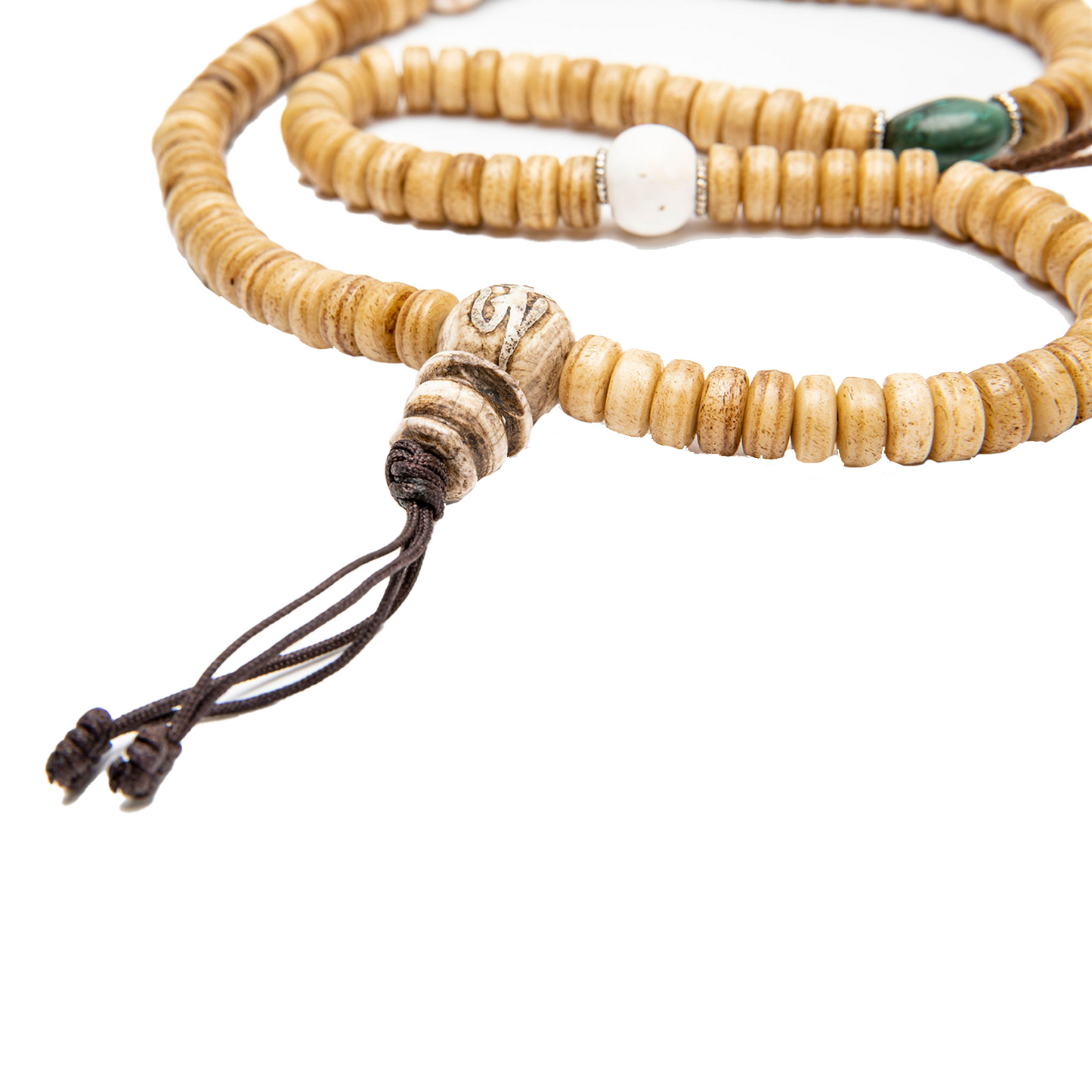 Close-up of the guru bead and knot of the Yak Bone Disc-Shaped Mala against a solid white backdrop.