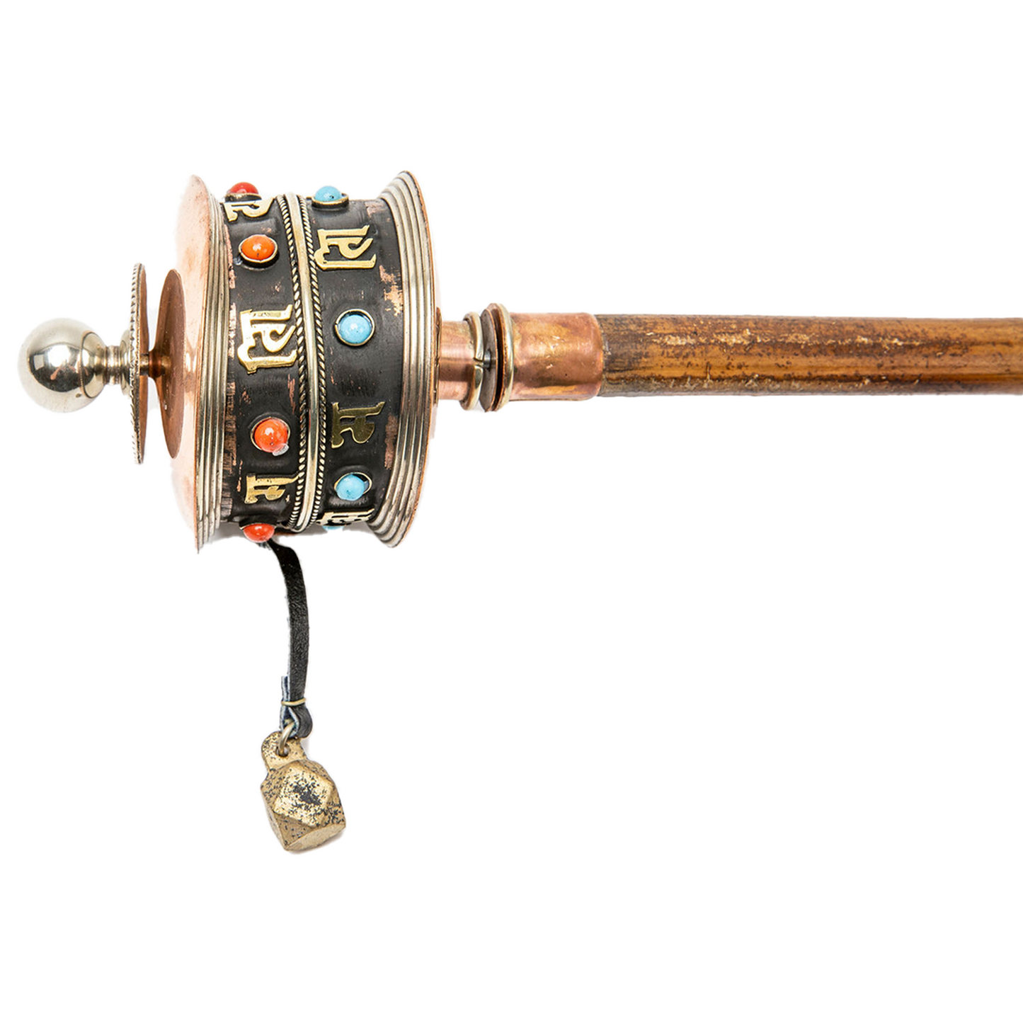 Close-up of top of big Handheld Prayer Wheel as it rests horizontally on a solid white backdrop.